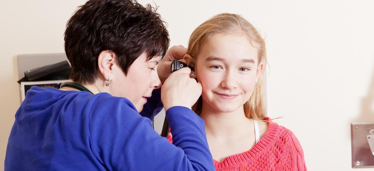 nurse looking at young patient